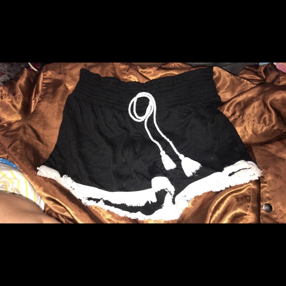 Black shorts with white strings and ruffles